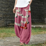 Noémie – Pantalon large rose à motif de grues