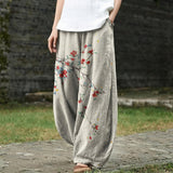 Denise – Pantalon large beige à motif de feuilles rouges